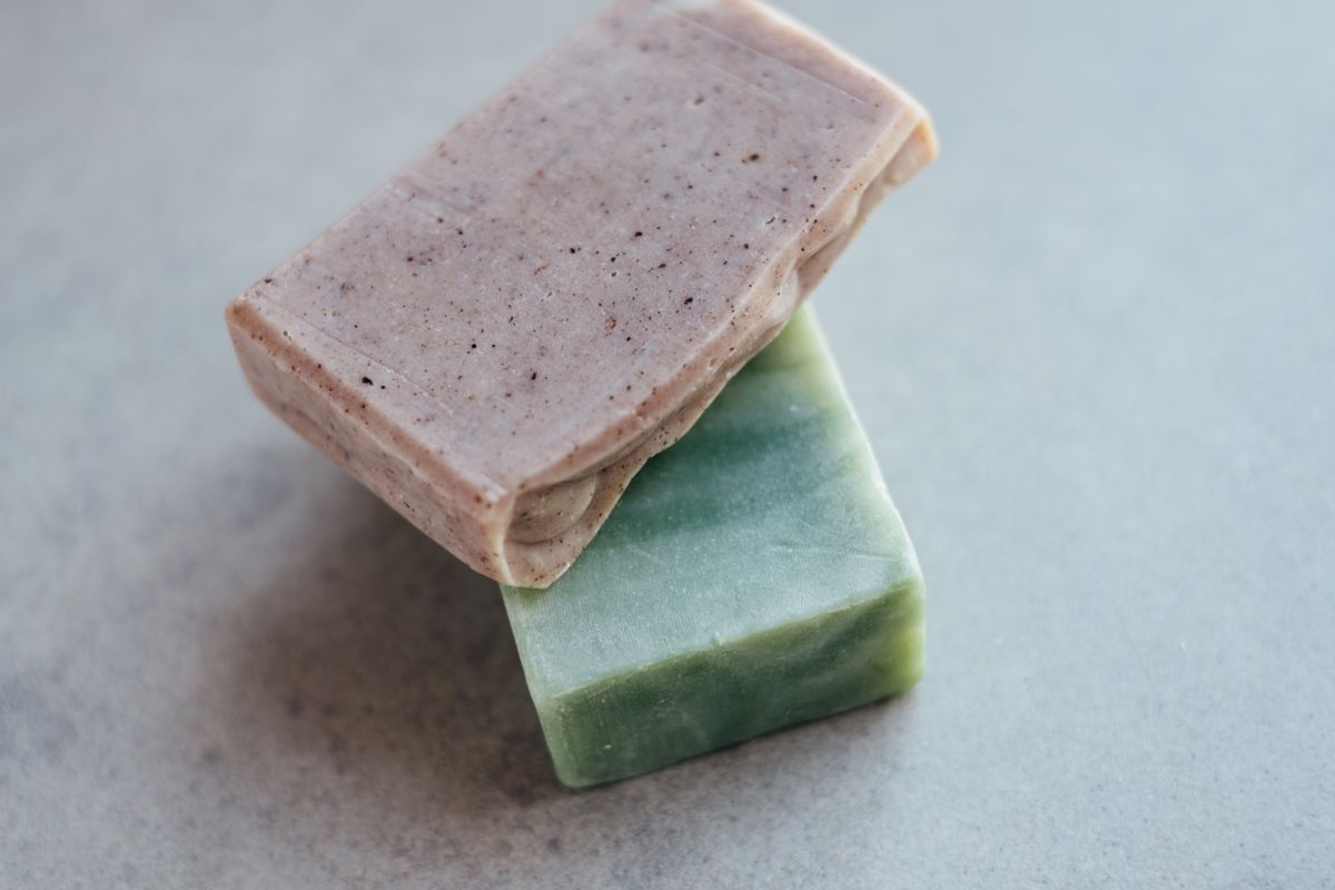 A pink clay and a green handmade soap bar stacked